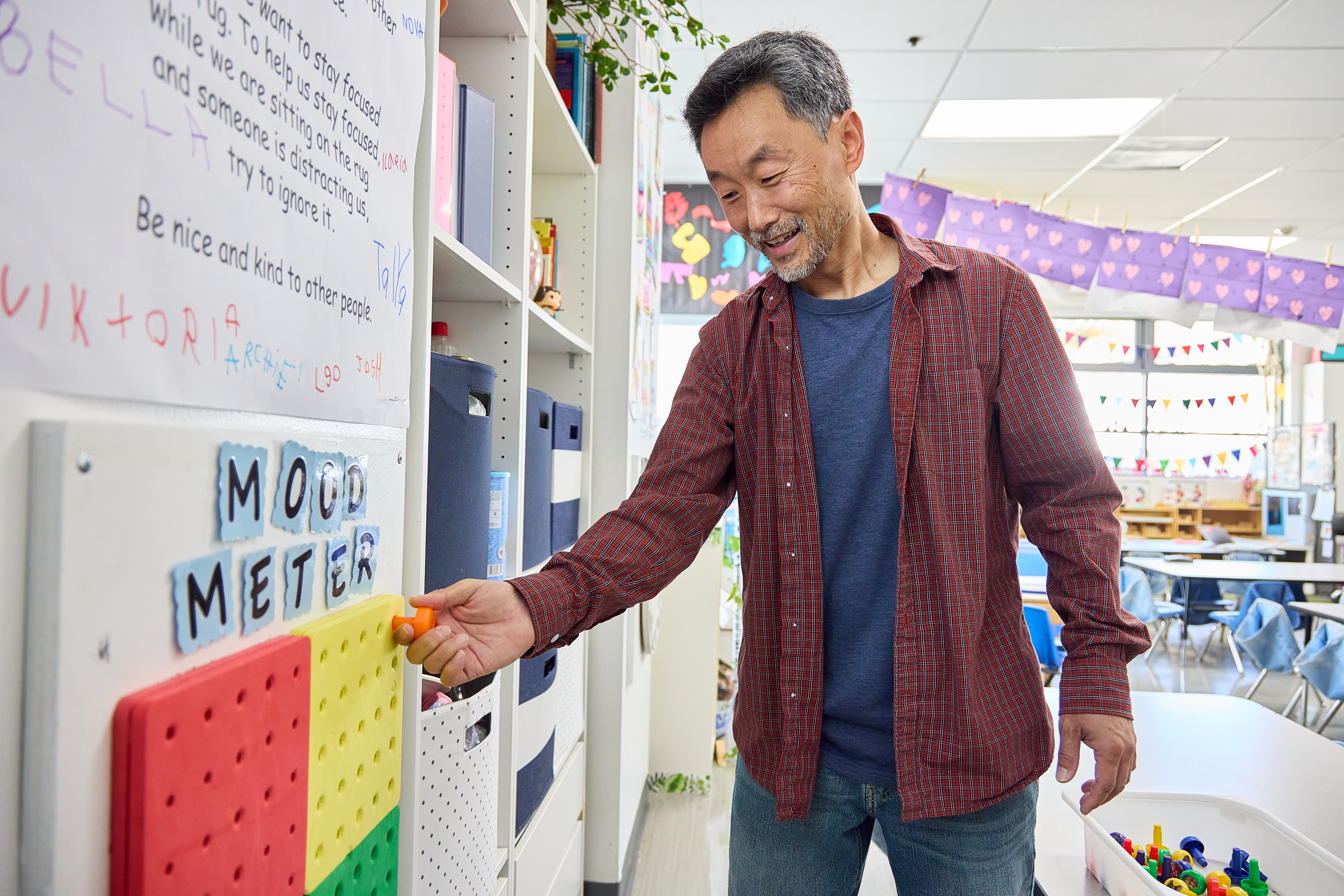Teacher pointing to a classroom Mood Meter chart as part of RULER implementation